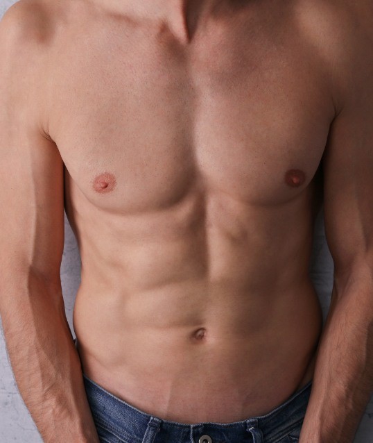 Closeup of man's muscular chest and stomach after vaser 4 D liposculpt