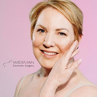 Woman with smooth skin after visiting Wiesman Cosmetic Surgery