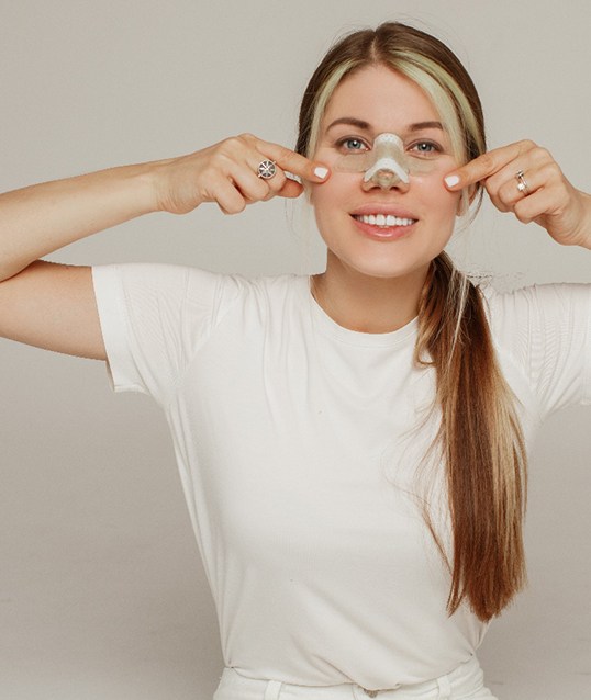 Woman wearing bandage on her nose after a nose job