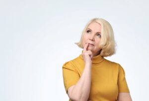 Mature woman wearing thoughtful, curious expression