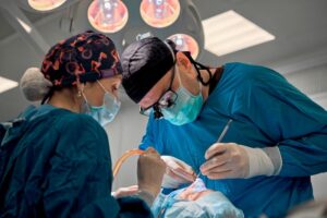 Surgical team carefully working on patient’s nose 