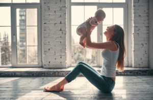 Attractive mom playing with her baby