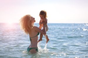 Confident mom in bikini after mommy makeover in Chicago